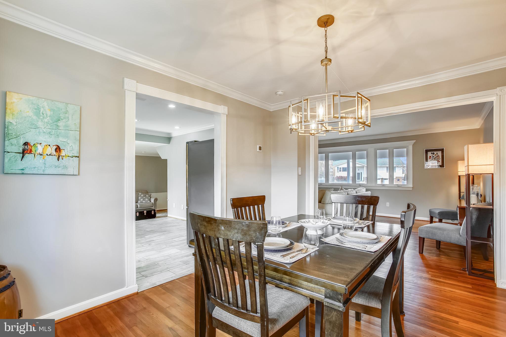 6005 Filbert Court Springfield, VA 22152 - Photo 18 of 55 a view of a dining room with furniture a chandelier and wooden floor