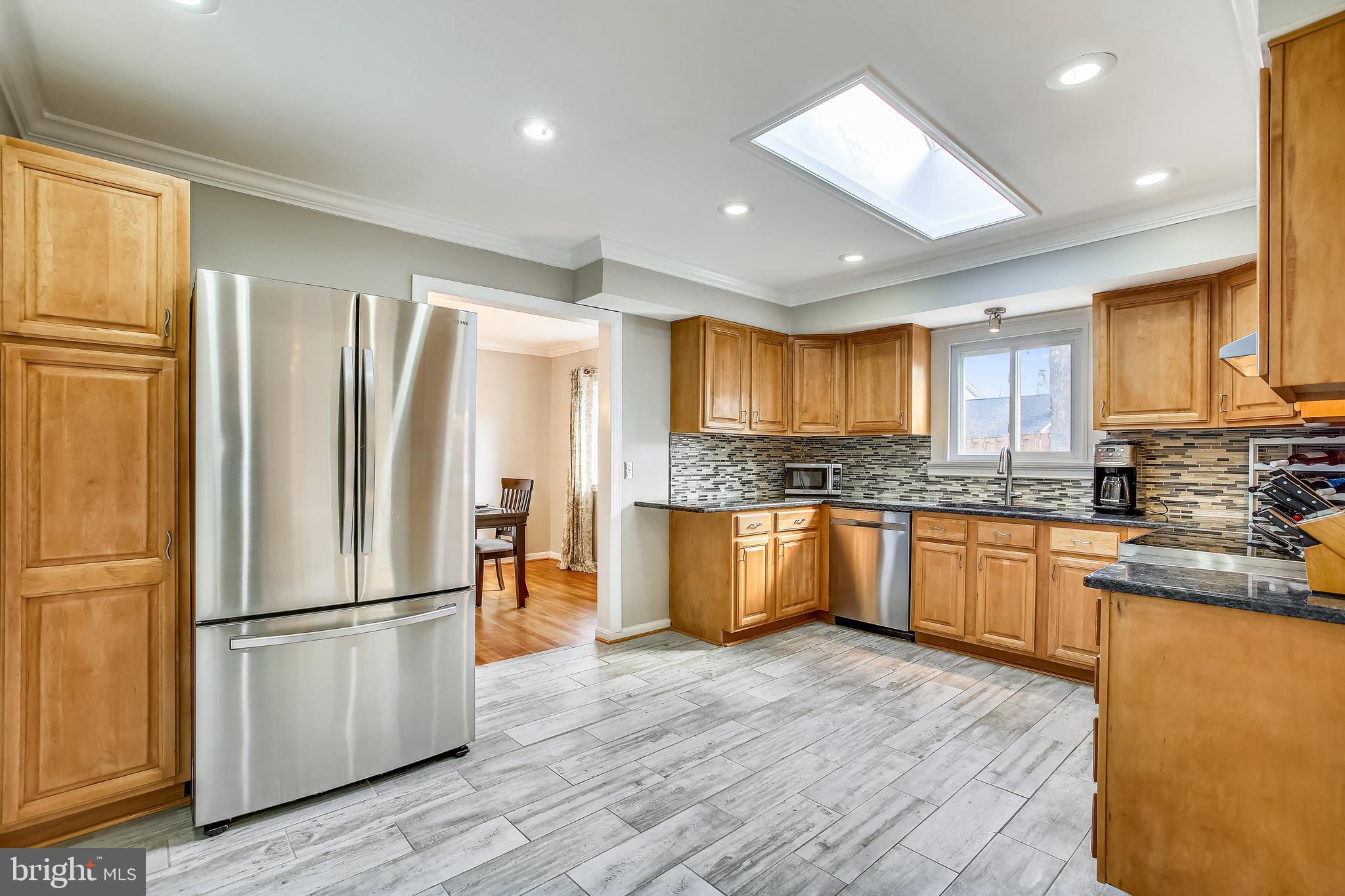 6005 Filbert Court Springfield, VA 22152 - Photo 20 of 55 a kitchen with granite countertop stainless steel appliances a refrigerator cabinets and wooden floor