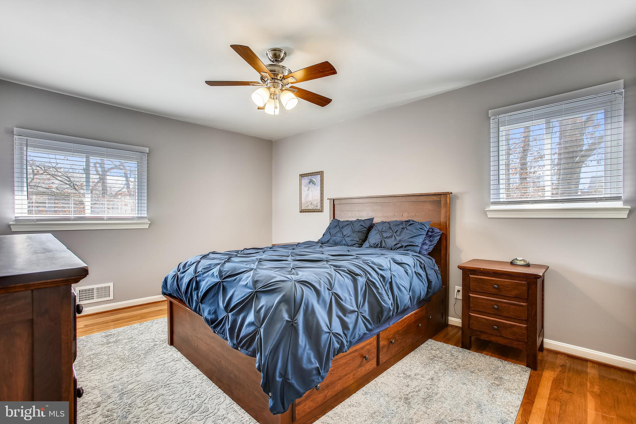 6005 Filbert Court Springfield, VA 22152 - Photo 29 of 55 a bedroom with a large bed and a chandelier