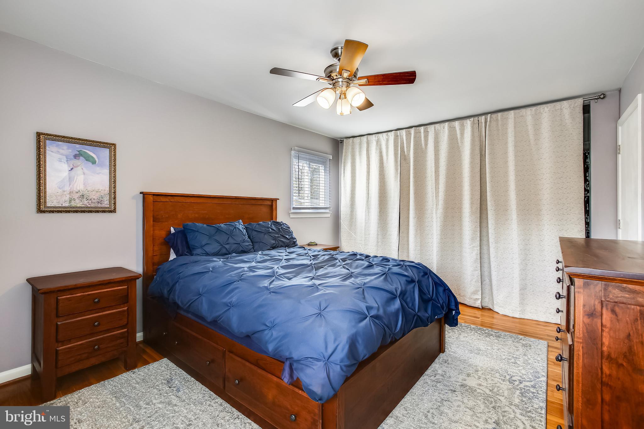 6005 Filbert Court Springfield, VA 22152 - Photo 30 of 55 a bedroom with a bed and a chandelier