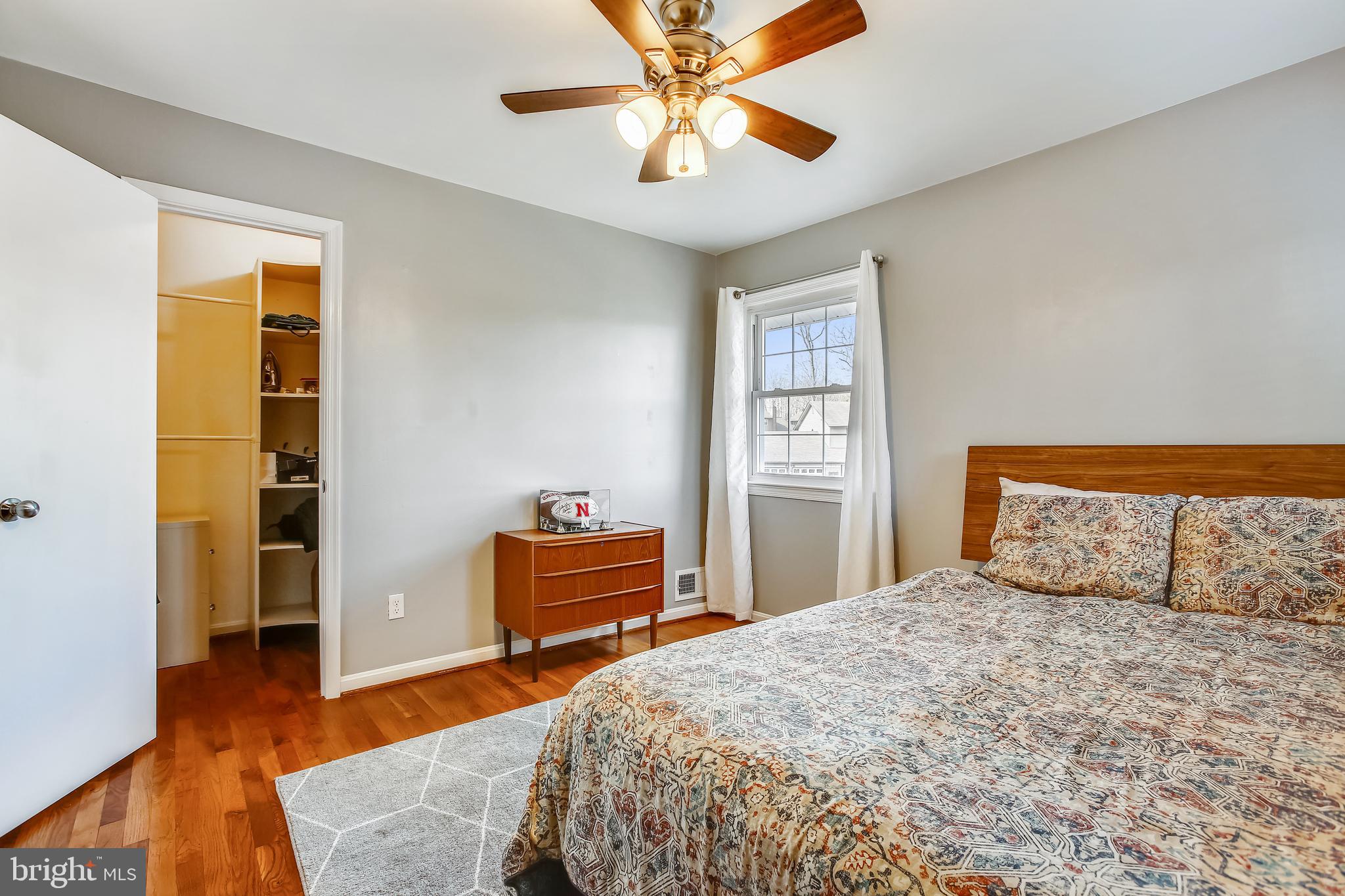 6005 Filbert Court Springfield, VA 22152 - Photo 37 of 55 a bedroom with a bed and wooden floor