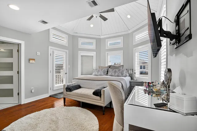 a spacious bathroom with a granite countertop sink a toilet a shower and a mirror