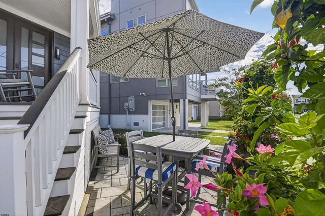 a view of a patio with furniture and a umbrella