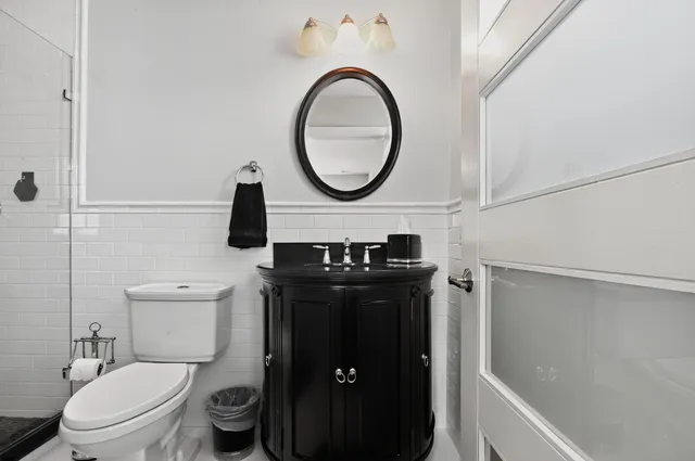 a bathroom with a toilet and a shower