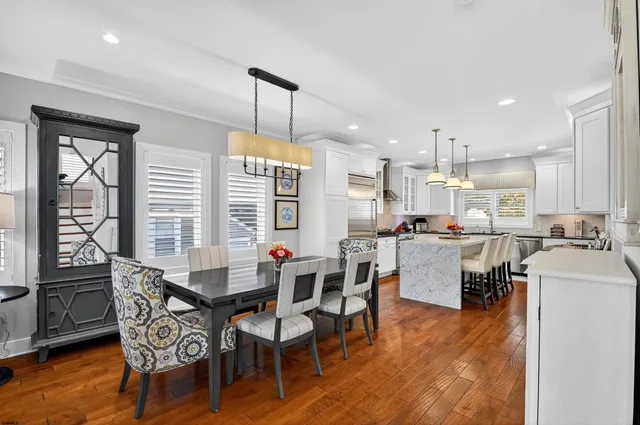 a dining room with furniture a rug and wooden floor
