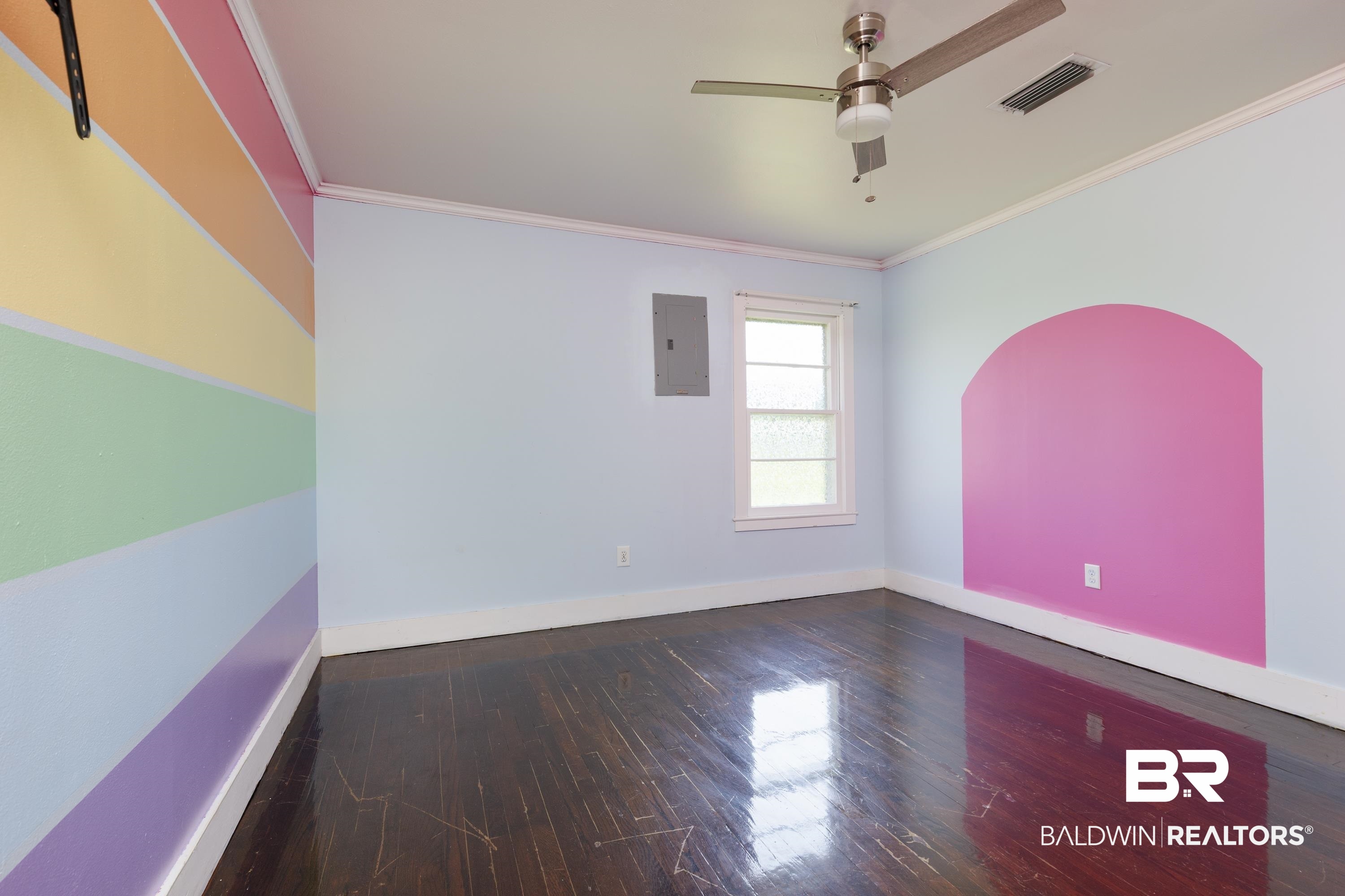 208 Beck Street Atmore, AL 36502 - Photo 22 of 26 Empty room featuring electric panel, ornamental molding, ceiling fan, and wood finished floors