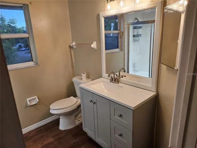 a bathroom with a sink toilet and mirror