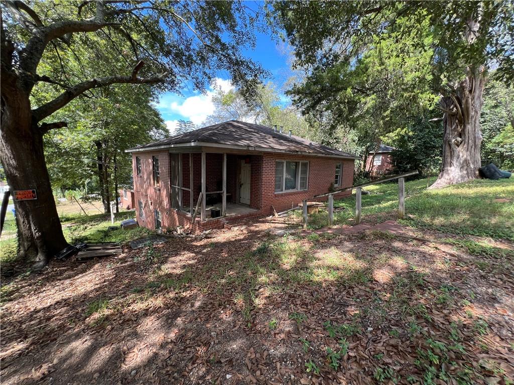 a view of a house with yard and tree s