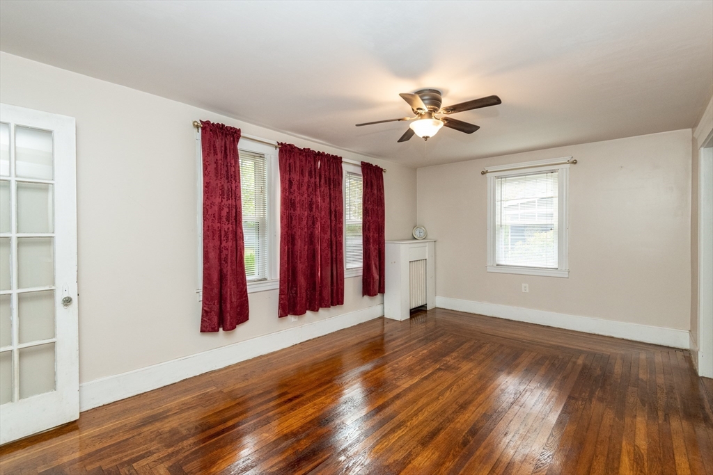 8 Newcomb Avenue Saugus, MA 01906 - Photo 11 of 37 a view of a room with wooden floors and a ceiling fan