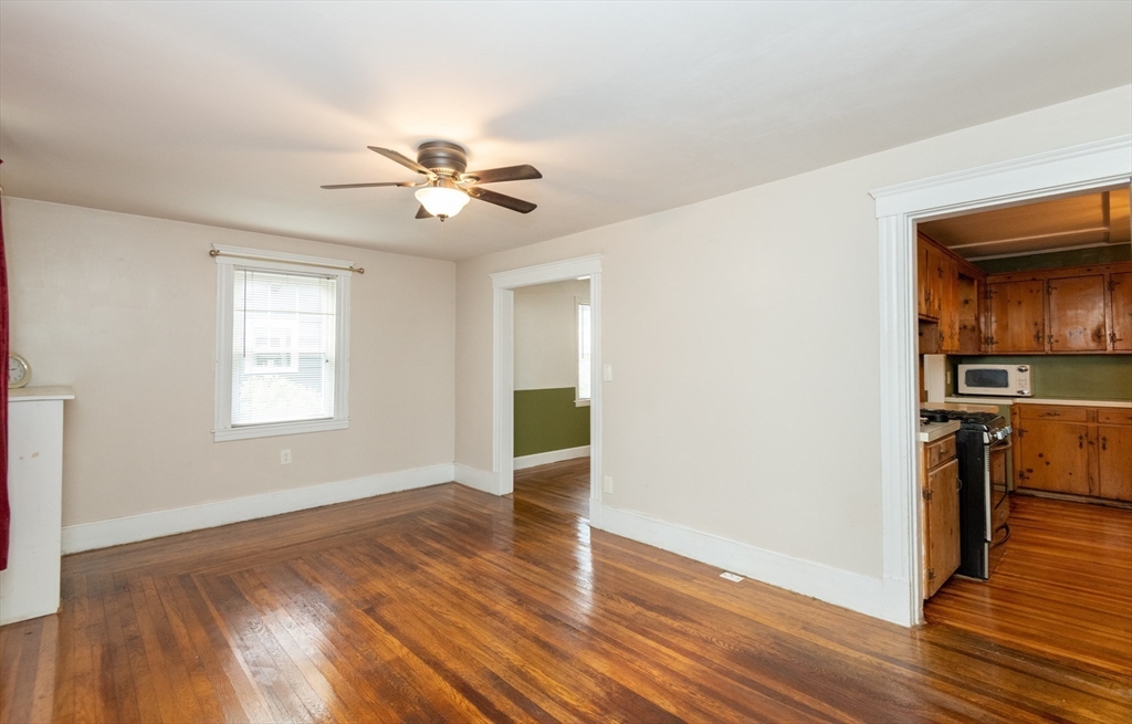 8 Newcomb Avenue Saugus, MA 01906 - Photo 13 of 37 a view of a kitchen with wooden floor a ceiling fan and windows