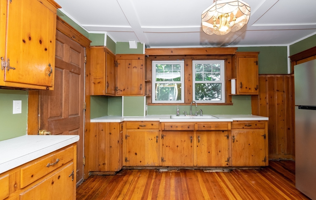 8 Newcomb Avenue Saugus, MA 01906 - Photo 14 of 37 a kitchen with wooden floors and refrigerator