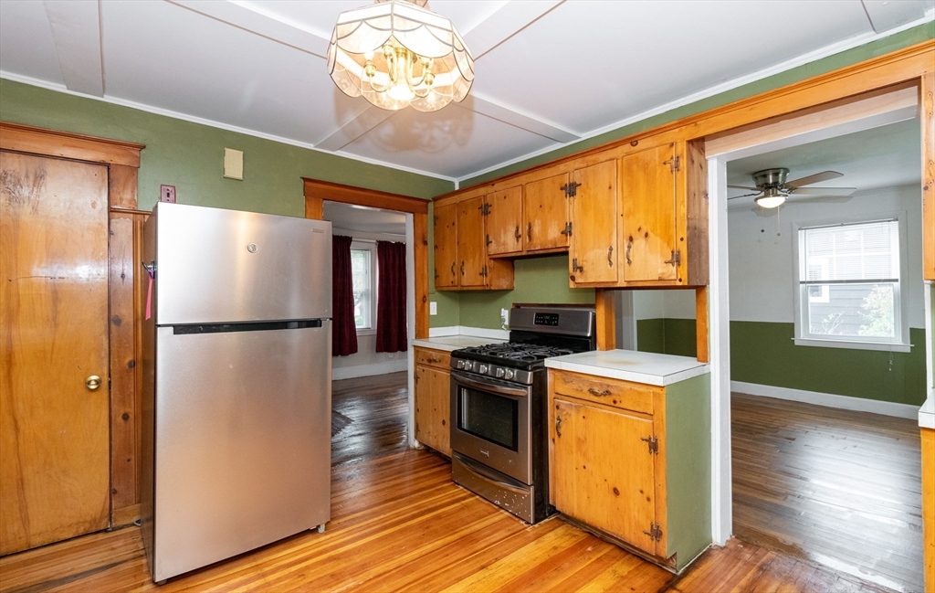 8 Newcomb Avenue Saugus, MA 01906 - Photo 15 of 37 a kitchen with a refrigerator a stove cabinets and wooden floor
