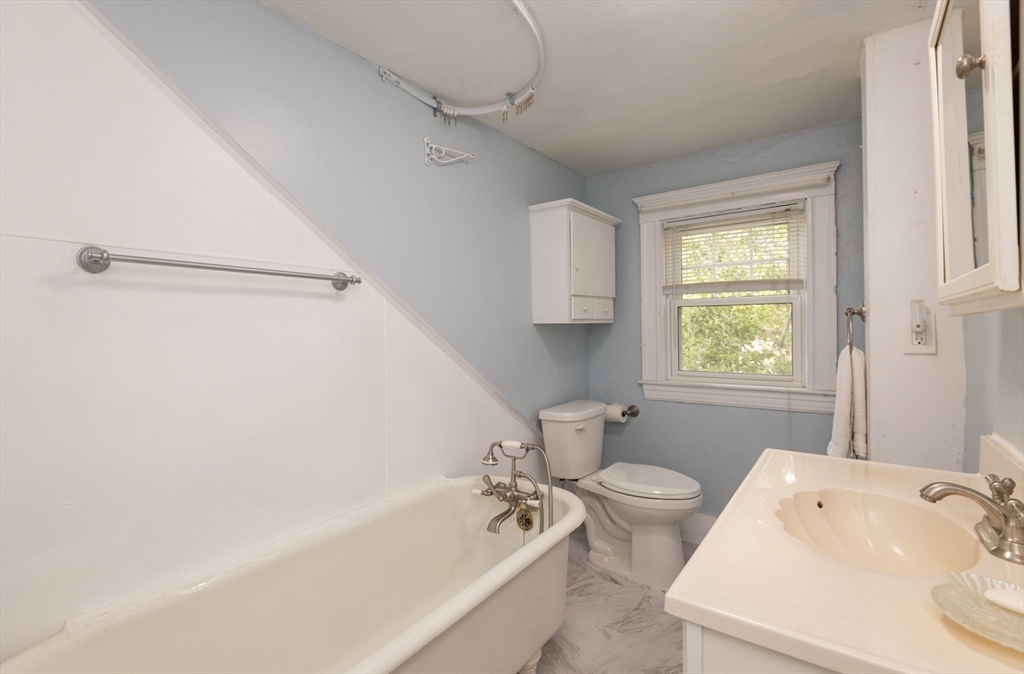 8 Newcomb Avenue Saugus, MA 01906 - Photo 20 of 37 a white bath tub sitting next to a white toilet and a window