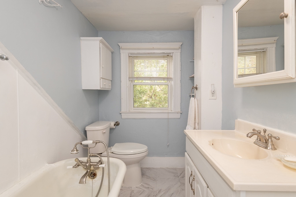 8 Newcomb Avenue Saugus, MA 01906 - Photo 23 of 37 a bathroom with a sink a toilet and mirror