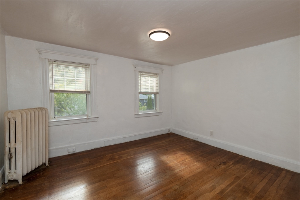 8 Newcomb Avenue Saugus, MA 01906 - Photo 25 of 37 an empty room with wooden floor and windows