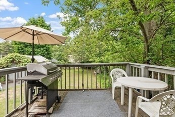 8 Newcomb Avenue Saugus, MA 01906 - Photo 31 of 37 a roof deck with a table and chairs under an umbrella