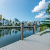 a view of a lake with a yard and a large trees