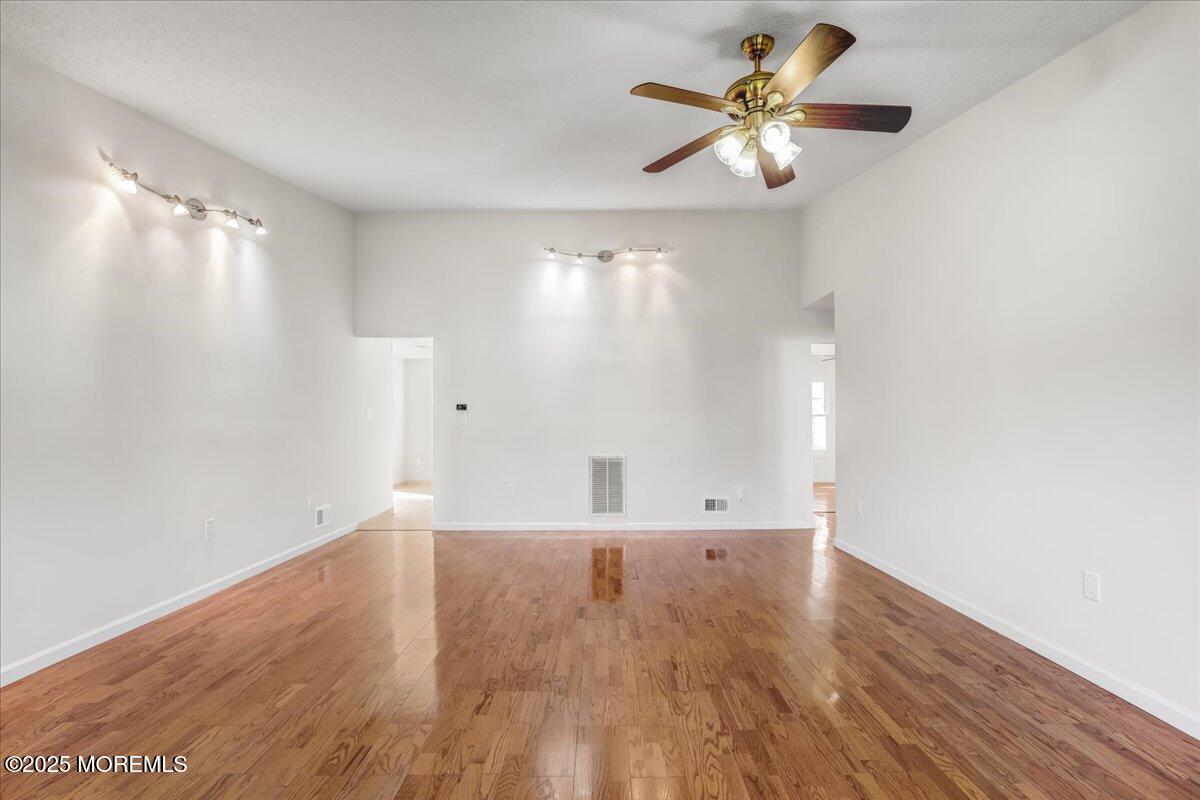 5 Jaffreyton Close Freehold, NJ 07728 - Photo 16 of 39 a view of an empty room with window and wooden floor