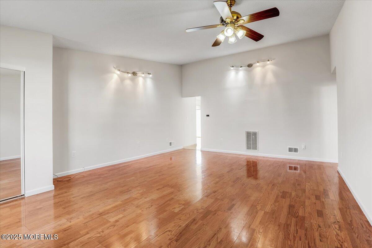 5 Jaffreyton Close Freehold, NJ 07728 - Photo 17 of 39 wooden floor in an empty room with a window