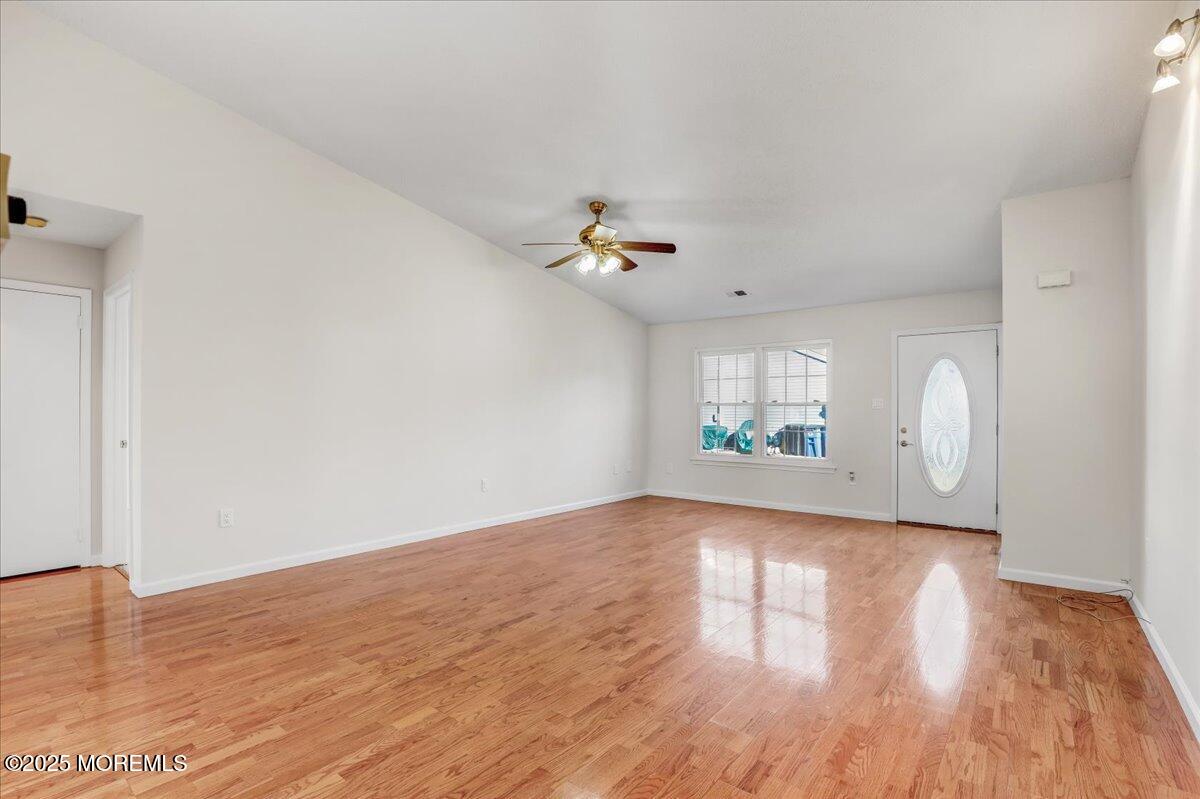 5 Jaffreyton Close Freehold, NJ 07728 - Photo 20 of 39 a view of an empty room with wooden floor and a window
