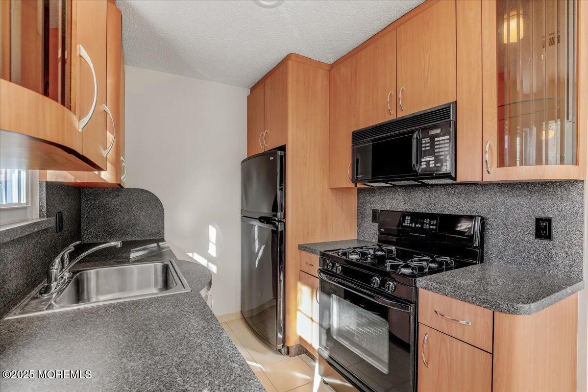 5 Jaffreyton Close Freehold, NJ 07728 - Photo 24 of 39 a kitchen with stainless steel appliances granite countertop a sink stove microwave and refrigerator