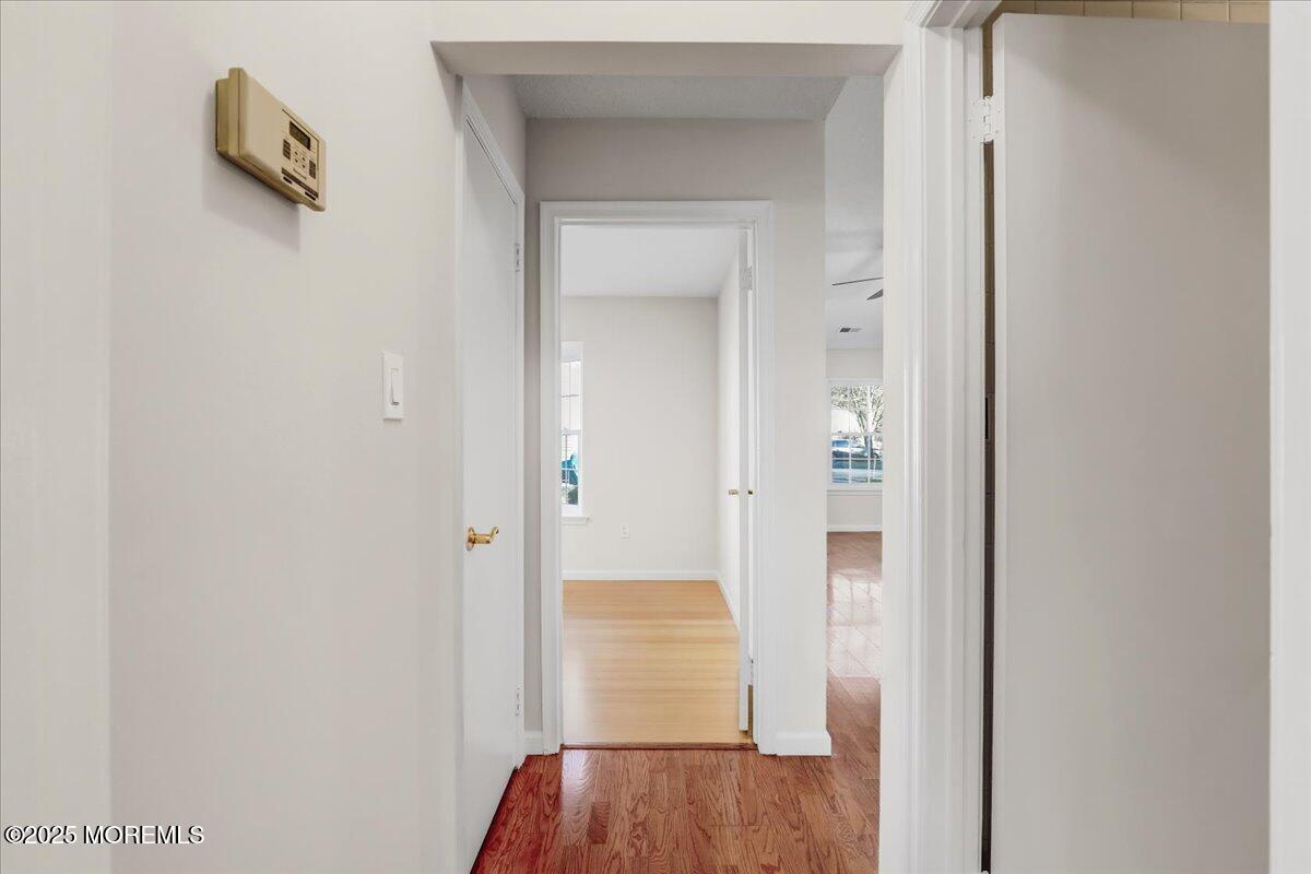 5 Jaffreyton Close Freehold, NJ 07728 - Photo 32 of 39 a view of a hallway with wooden floor and closet