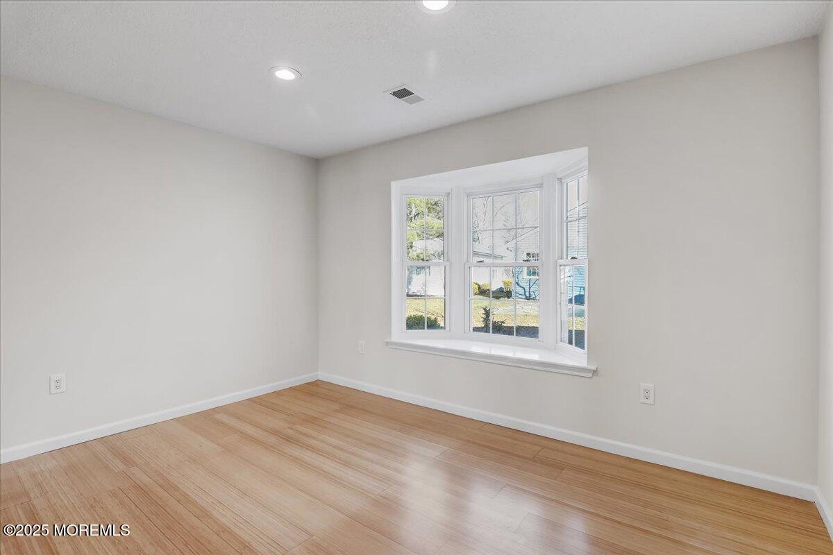 5 Jaffreyton Close Freehold, NJ 07728 - Photo 36 of 39 an empty room with wooden floor and windows