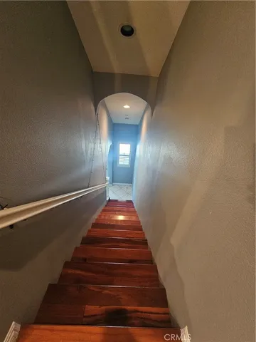 a view of a hallway with wooden floor and a fireplace