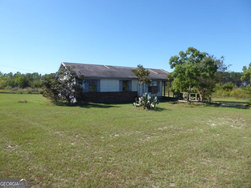 15 Hawthorn Road Hazlehurst, GA 31539 - Photo 1 of 1 a view of a house with a yard porch and sitting area