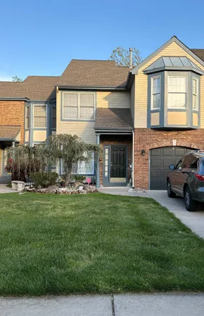 a front view of a house with a garden and yard