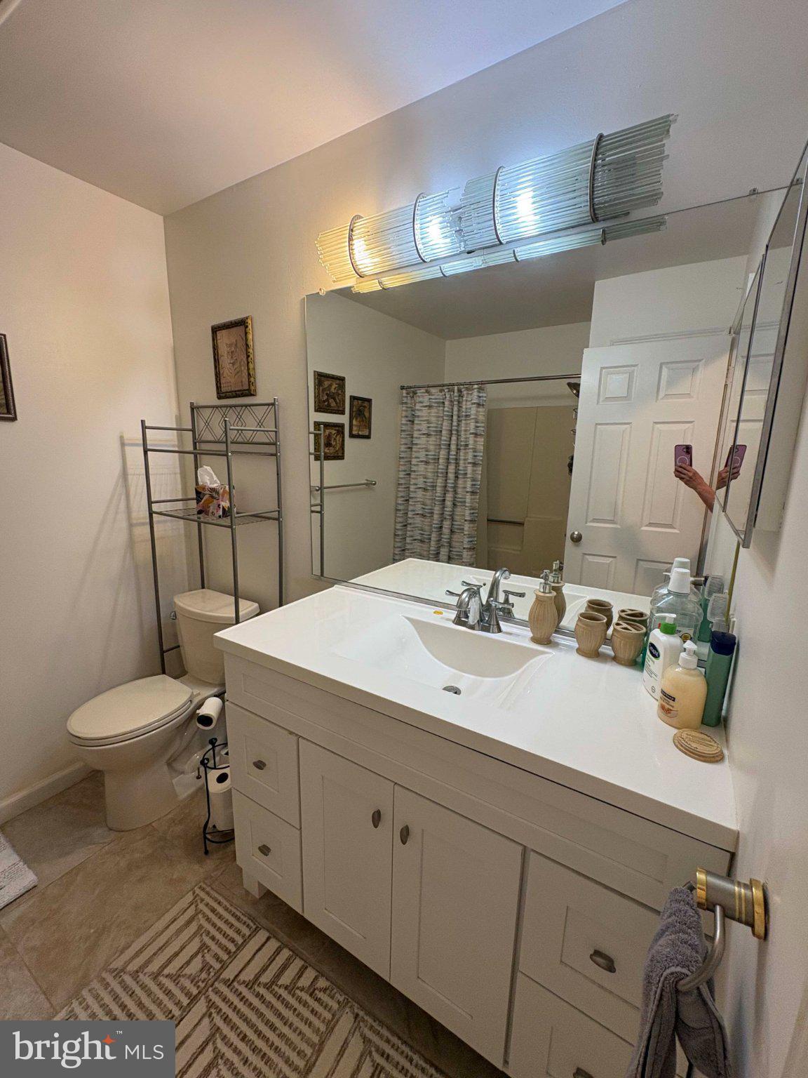 5 Corlen Court, Unit 5 Medford, NJ 08055 - Photo 15 of 33 a bathroom with a toilet a sink and mirror