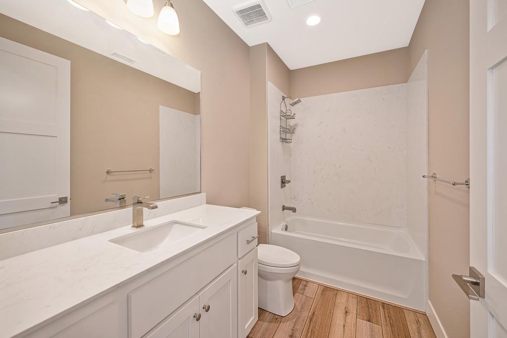 504 Chase Court Colfax, CA 95713 - Photo 66 of 94 a bathroom with a sink a toilet and a large mirror