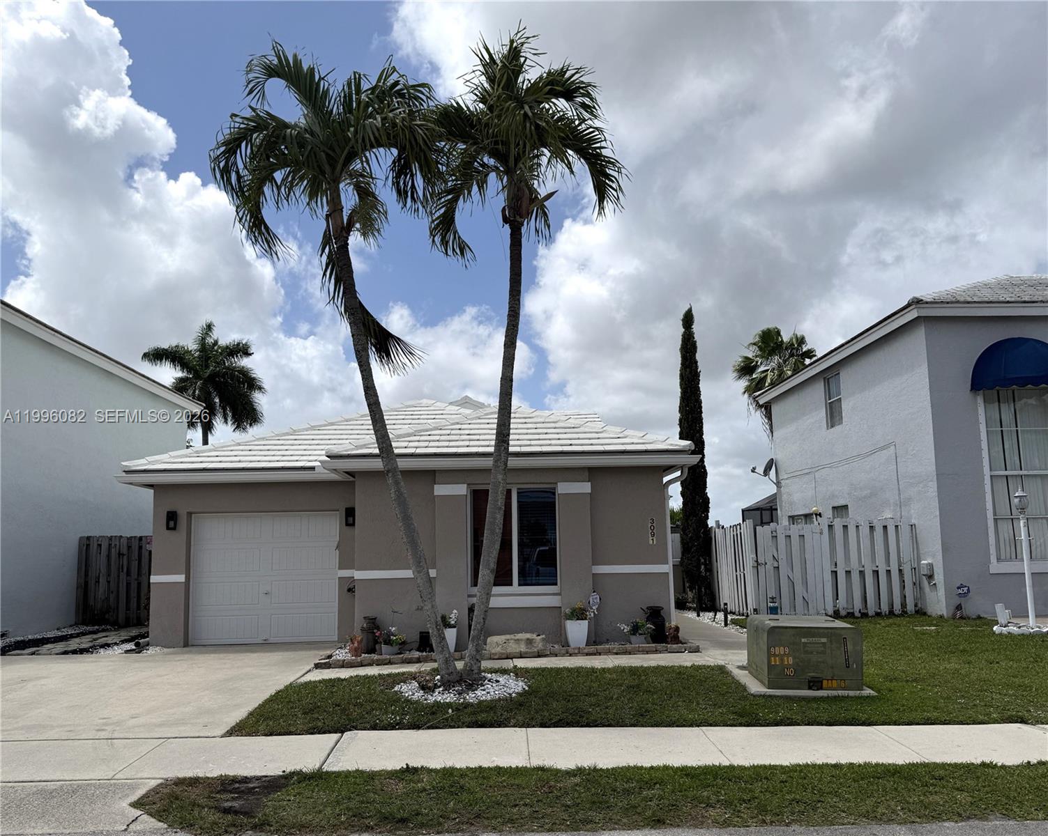 3091 Lighthouse Place Margate, FL 33063 - Photo 1 of 38 a front view of a house with garden