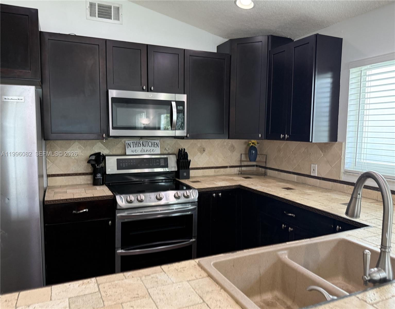 3091 Lighthouse Place Margate, FL 33063 - Photo 13 of 38 a kitchen with a sink stove and microwave