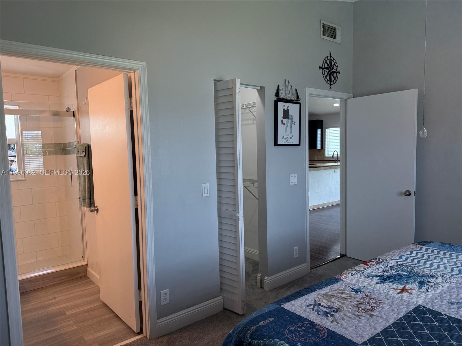 3091 Lighthouse Place Margate, FL 33063 - Photo 22 of 38 a bedroom with a bed and a walk in closet