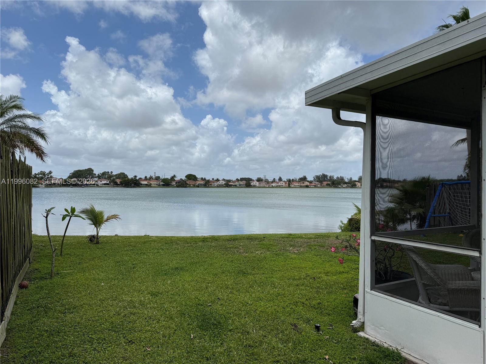 3091 Lighthouse Place Margate, FL 33063 - Photo 32 of 38 a view of a lake from a yard