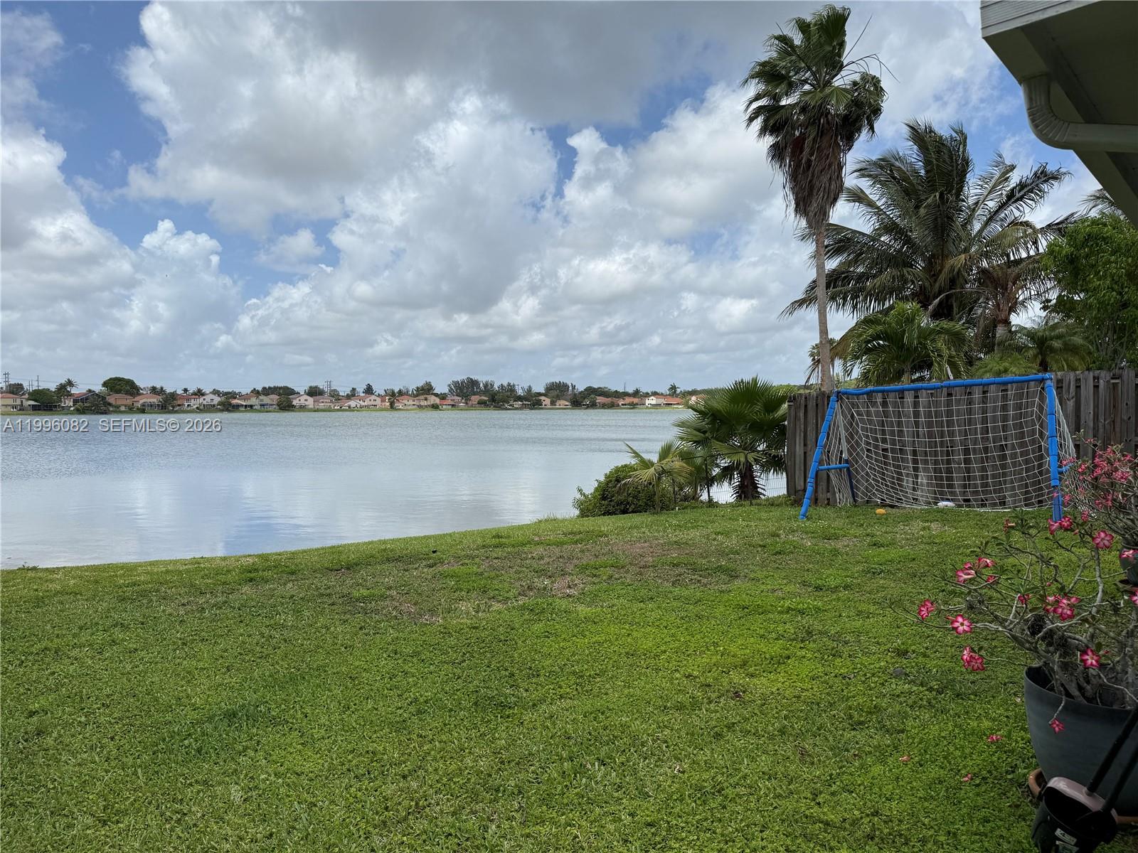 3091 Lighthouse Place Margate, FL 33063 - Photo 34 of 38 a view of a lake with a big yard