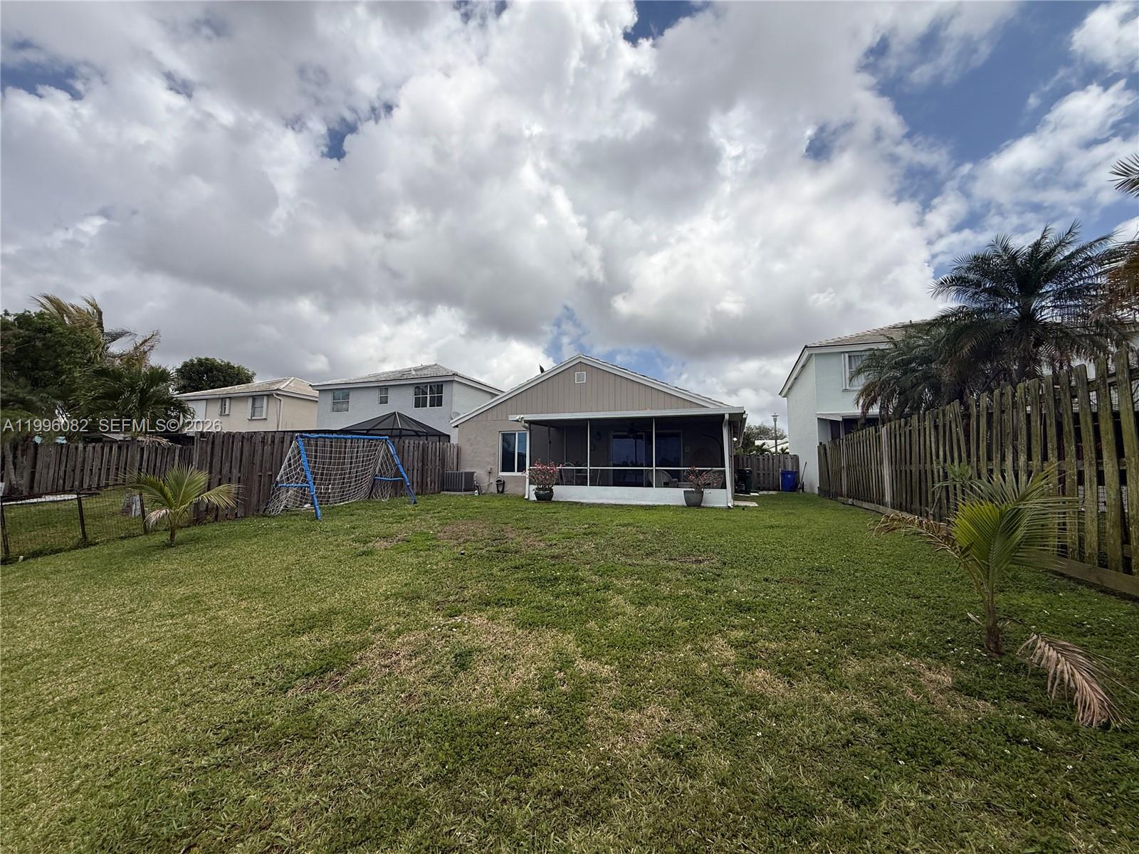 3091 Lighthouse Place Margate, FL 33063 - Photo 37 of 38 a view of a house with a big yard and a large tree