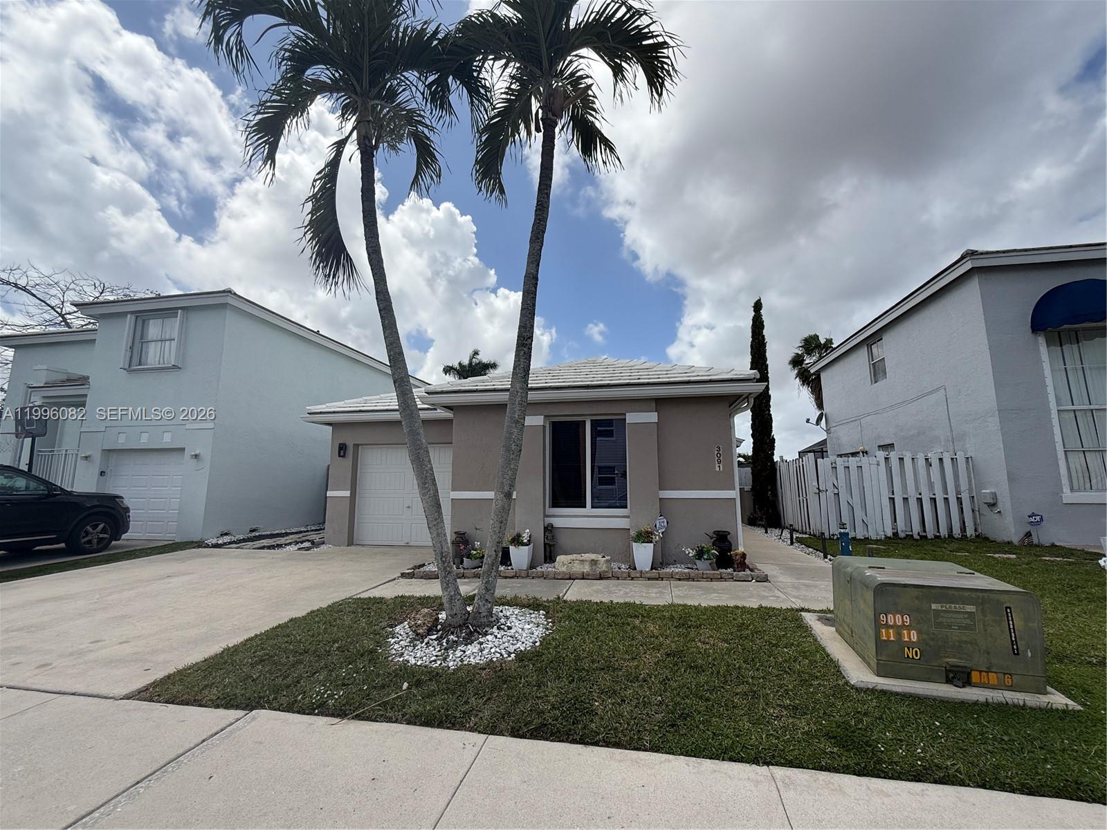 3091 Lighthouse Place Margate, FL 33063 - Photo 38 of 38 a front view of a house with garden