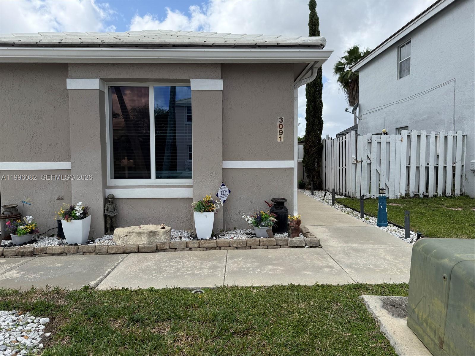 3091 Lighthouse Place Margate, FL 33063 - Photo 9 of 38 a front view of a house with garden