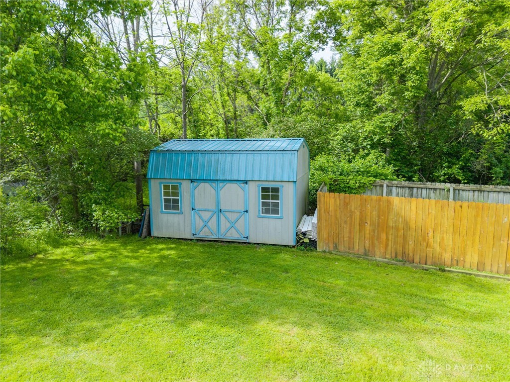 2165 Stewart Road Xenia, OH 45385 - Photo 47 of 59 This expansive yard features a charming shed, perfect for additional storage or a creative workspace.