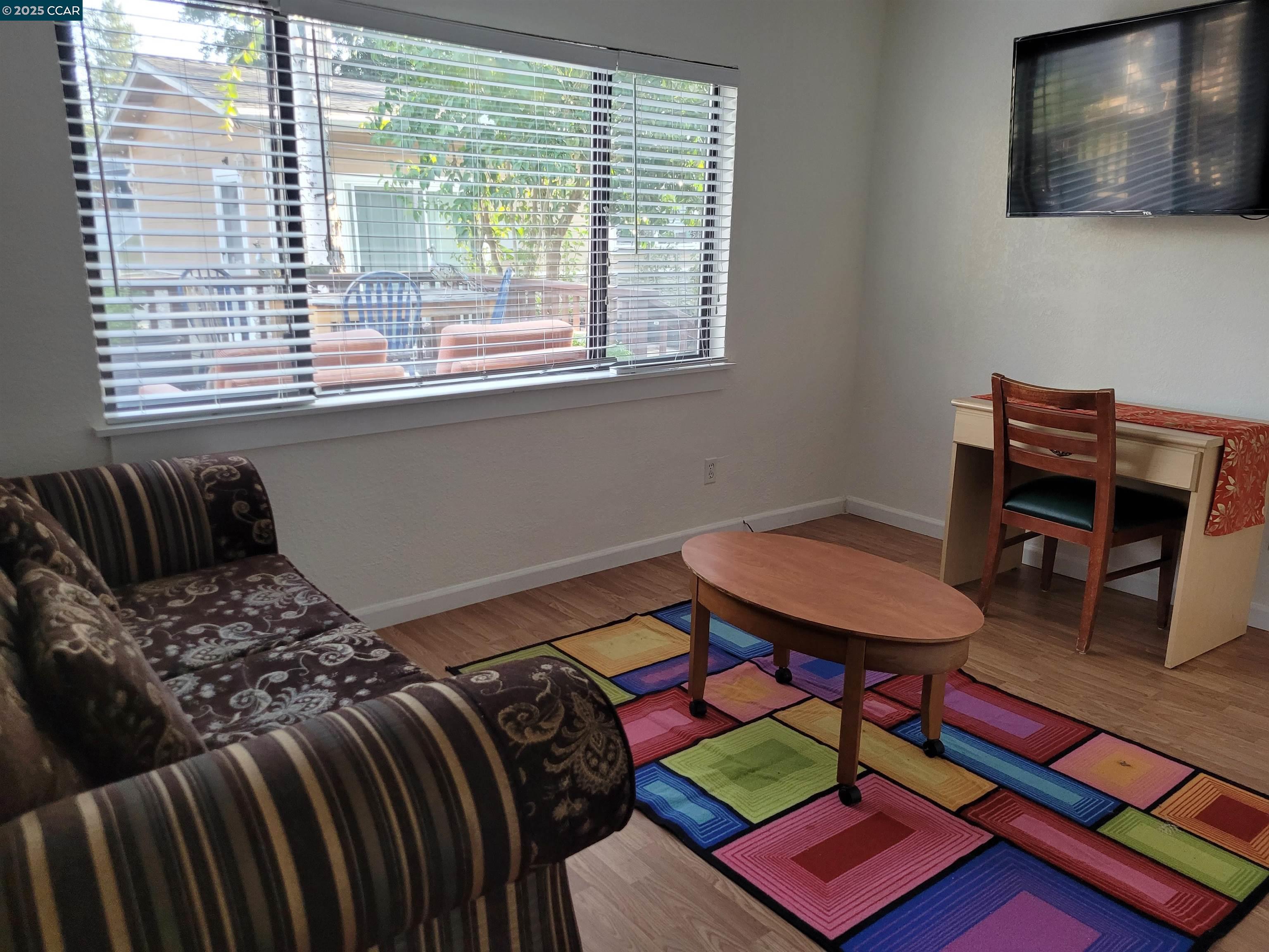 1181 Danville Boulevard, Unit E Alamo, CA 94507 - Photo 3 of 11 a bedroom with a bed and a bookshelf