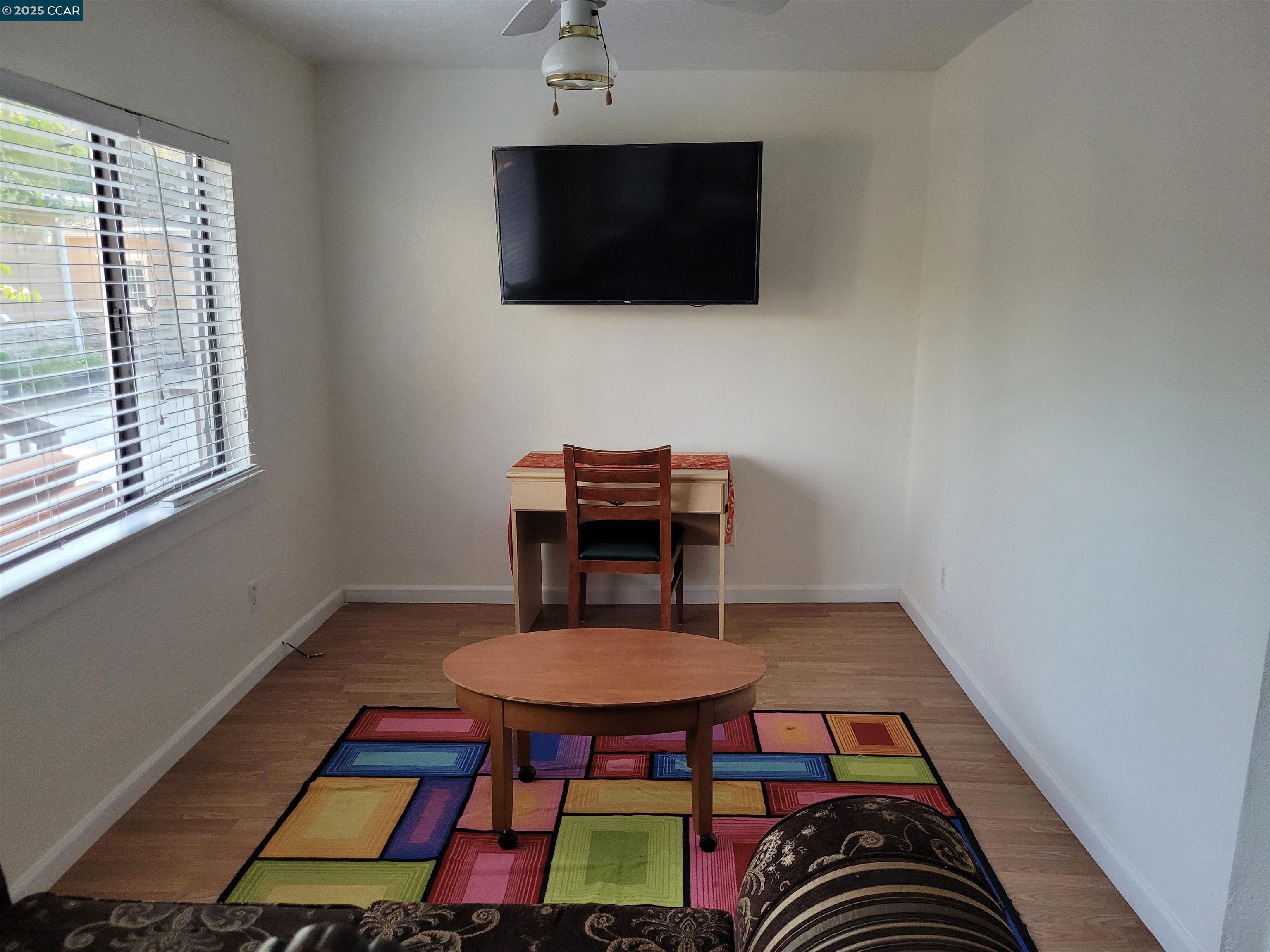 1181 Danville Boulevard, Unit E Alamo, CA 94507 - Photo 4 of 11 a living room with furniture and a flat screen tv