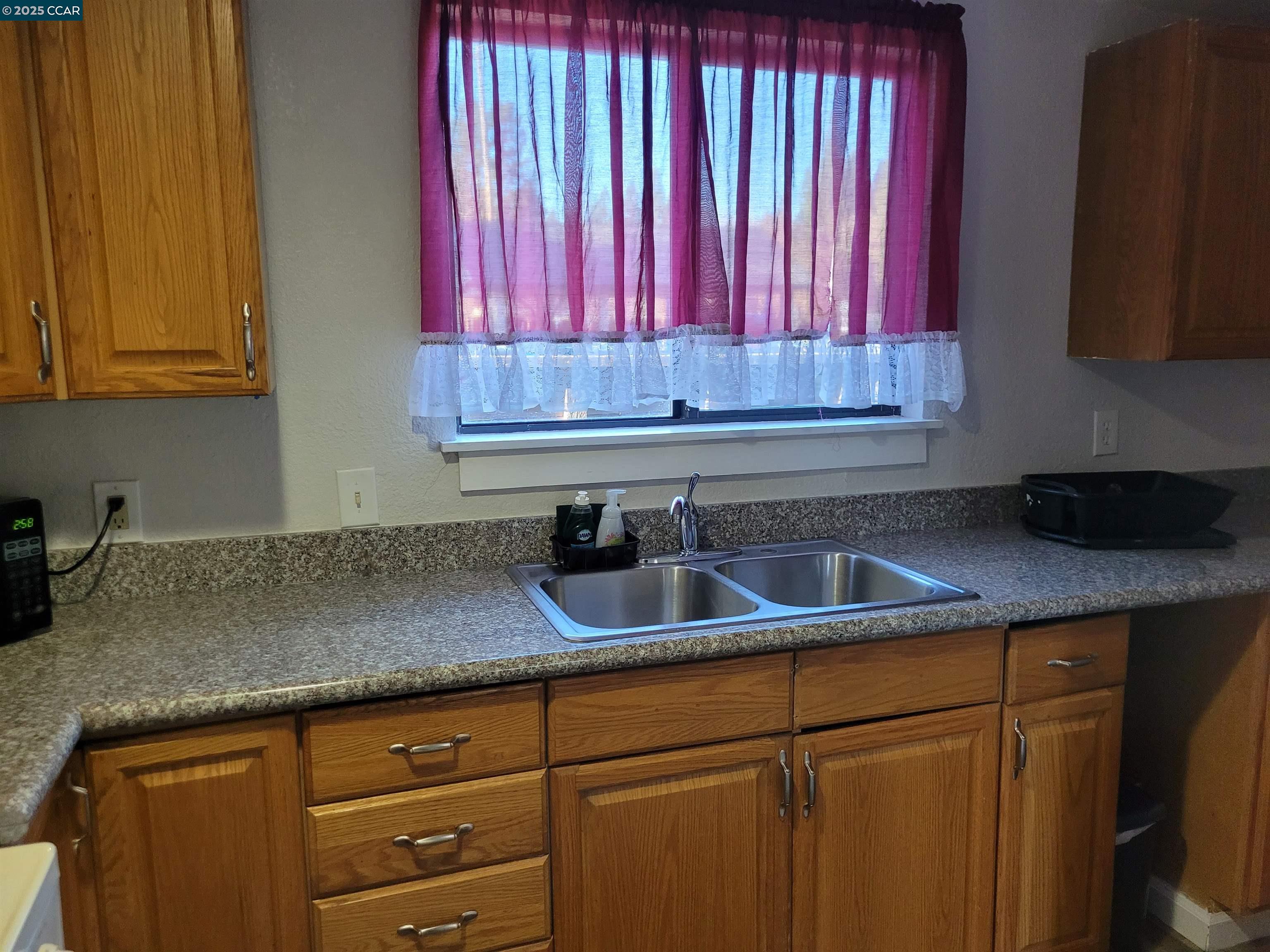 1181 Danville Boulevard, Unit E Alamo, CA 94507 - Photo 8 of 11 a kitchen with a sink cabinets and a window