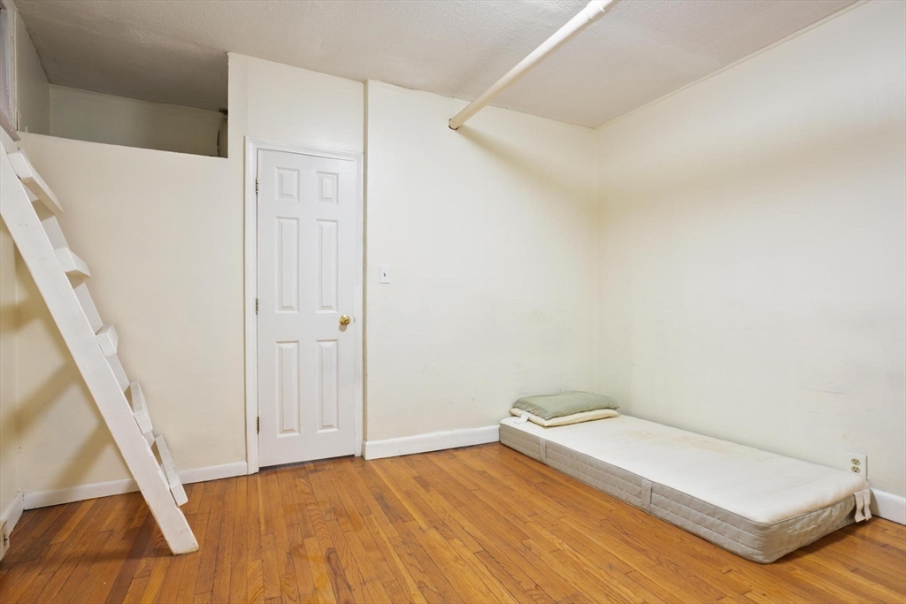 55 A Lanark Road, Unit A Boston, MA 02135 - Photo 12 of 18 a view of a room with wooden floor and white walls