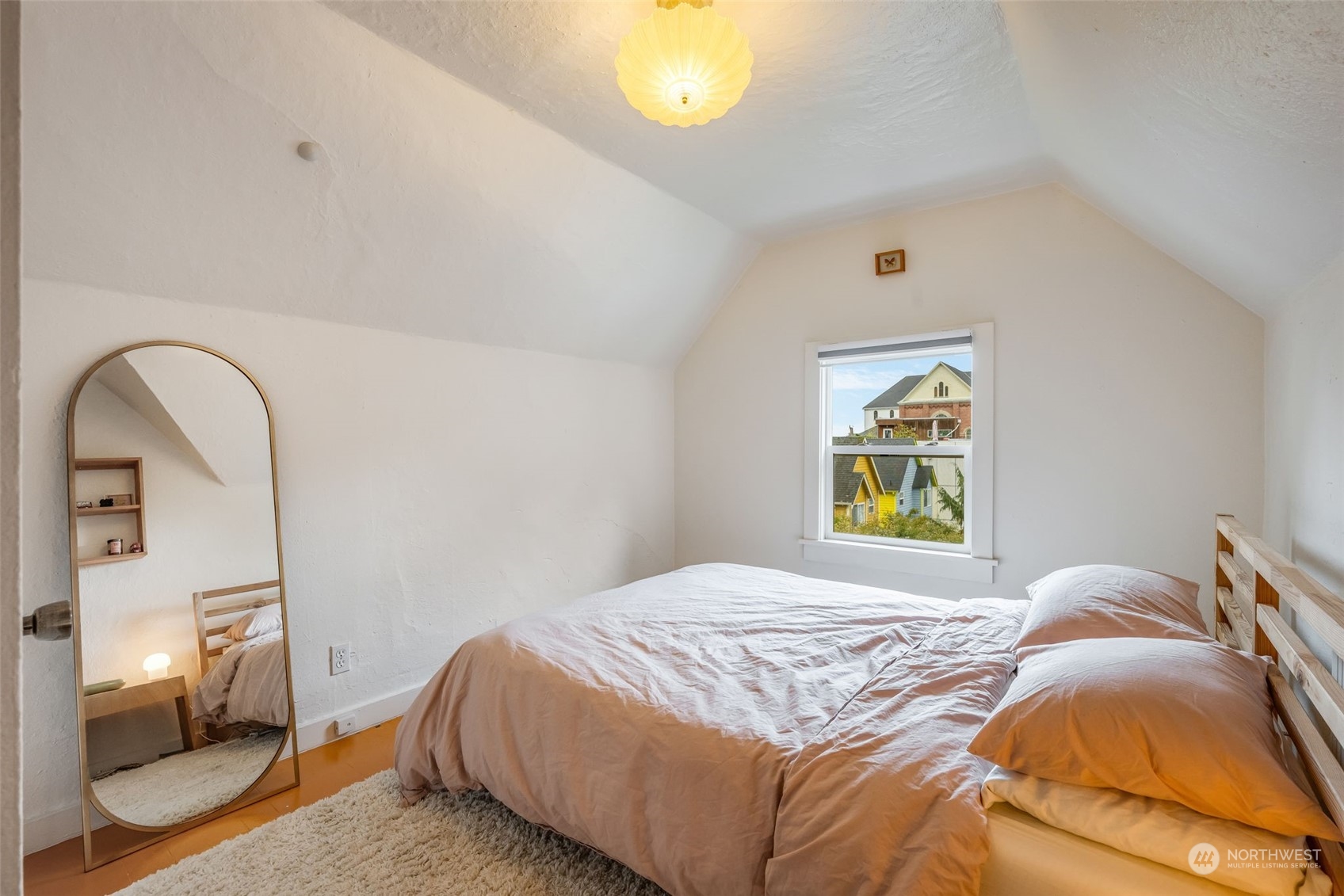 926 18th Avenue Seattle, WA 98122 - Photo 26 of 38 a bedroom with a bed and painting on the wall