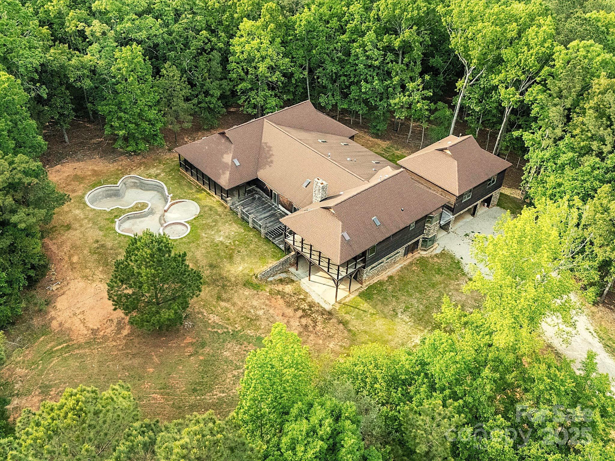 1055 Stone House Road Chapin, SC 29036 - Photo 2 of 30 an aerial view of a house with swimming pool and a yard
