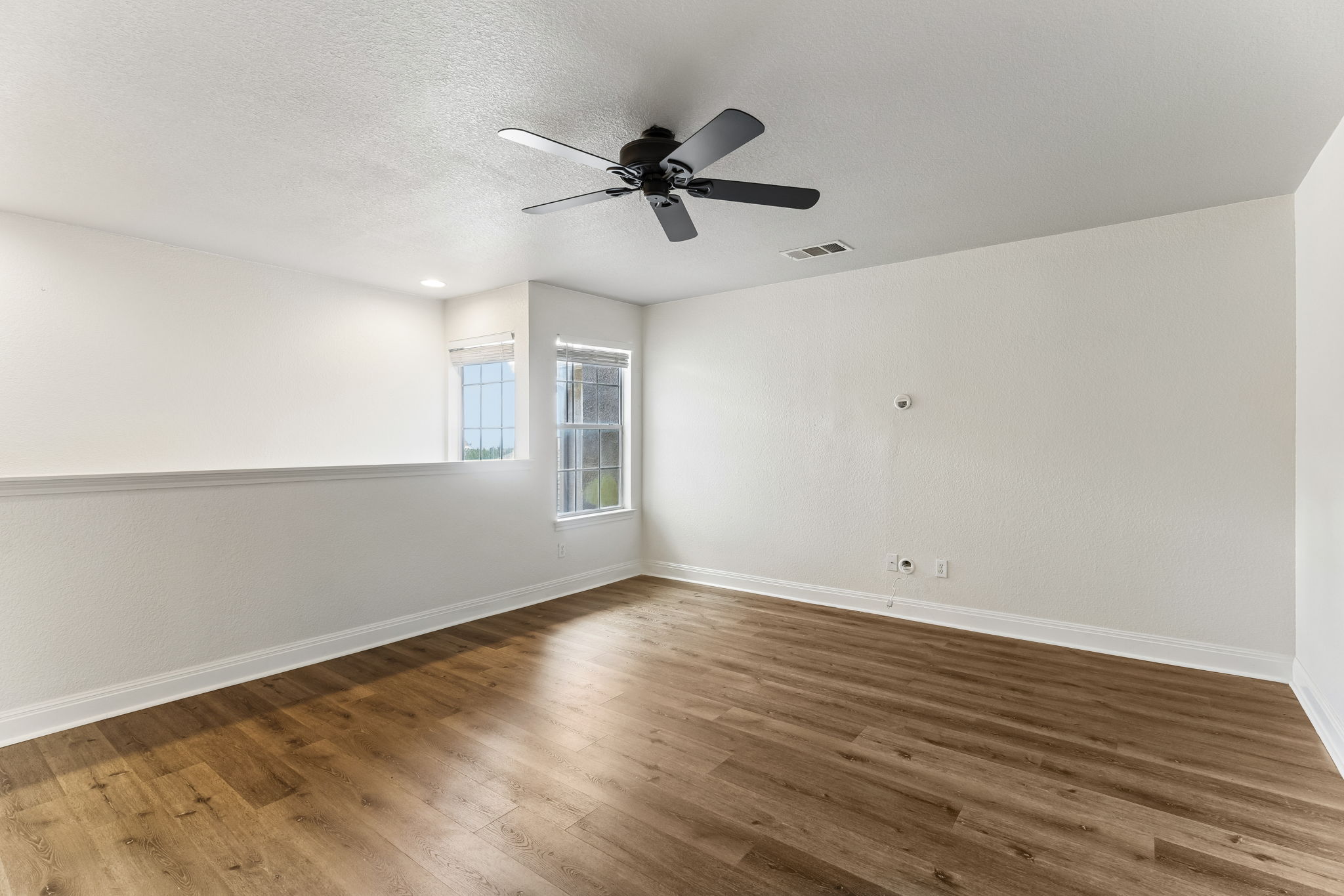 114 Aria Ridge, Unit 802 Lakeway, TX 78738 - Photo 24 of 37 An airy loft area features rich wood flooring and a refreshing ceiling fan.
