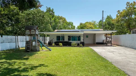 a view of a house with a yard and sitting area