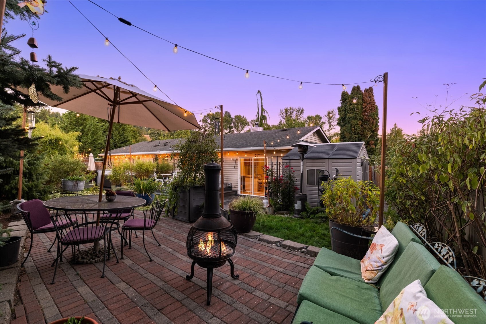 1313 228th Place Southwest Bothell, WA 98021 - Photo 17 of 23 a view of a patio with couches table and chairs under an umbrella